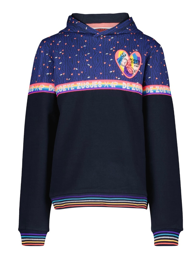 Hoodie Jinte uit de collectie van Zoete Zusjes x 4President. Bovenste gedeelte blauw met speelse hartjes. Tussenin een regenboog-band met tekst en onderste gedeelte is donker blauw. Vershillende maten beschikbaar.